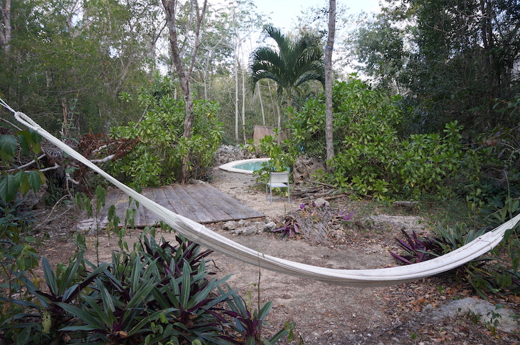 Hammock with a view of the pool at Bliss Eden Ayahuasca Retreat in Tulum, Quintana Roo, Mexico.