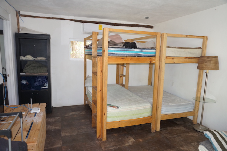 Guest room with double bunk bed at Bliss Eden Ayahuasca Retreat in Tulum, Quintana Roo, Mexico