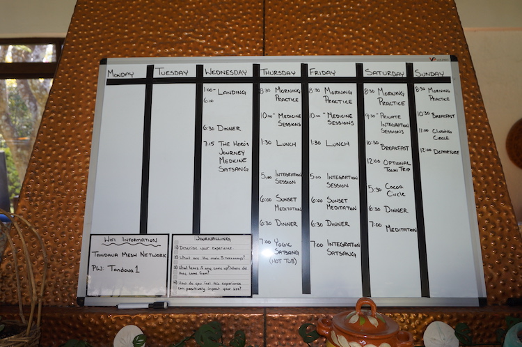 Daily schedule on the whiteboard at Tandava 5-MeO-DMT Retreats in Tepoztlan, Mexico