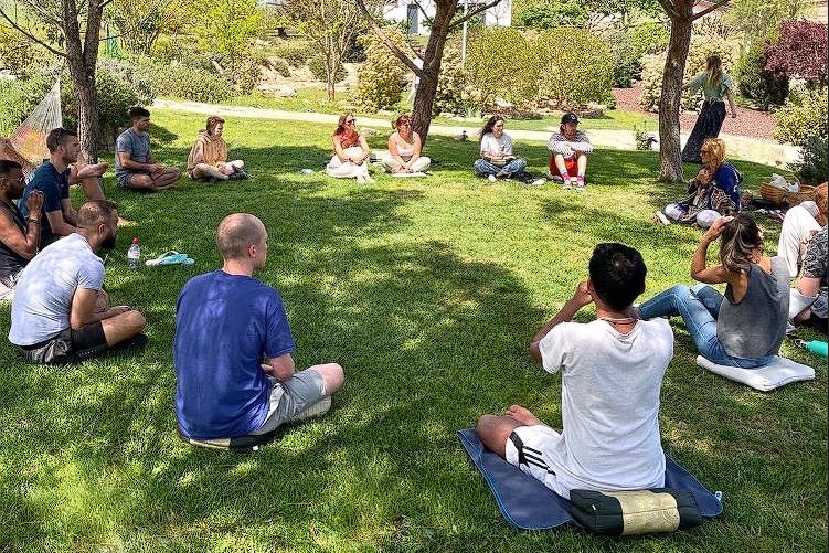 Gathering in nature's embrace for heartfelt conversations. Our sharing circle flourishes on this lush, green canvas, where stories and connections intertwine like the blades of grass beneath us at Energetics Explained Ayahuasca Retreat in Sant Salvador de Guardiola Barcelona Catalonia Spain