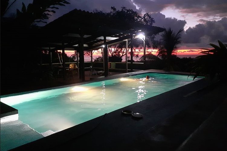 Bathed in the soft glow of moonlight, the pool at night exudes an aura of calm and serenity at Ikara Iboga Center Dominical Costa Rica