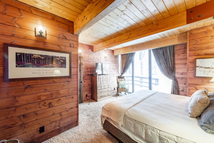 Your bedroom sanctuary awaits. This luxurious wooden design is the perfect place to relax and unwind, surrounded by the warmth and beauty of nature here at Healing Through Psychedelic Retreat in Park City Utah, USA