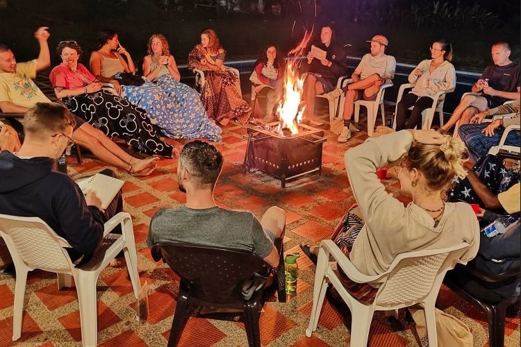 Gathered in a circle, our spirits aflame, we share stories, warmth, and the magic of the moment around the fire's glow here at here at Lawayra Ayahuasca retreat in Fredonia, Colombia