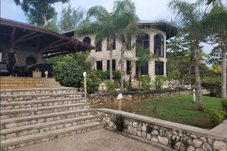 Find solace in the artistry of serenity at our retreat center, where every stone whispers tranquility. Our architecturally stunning stone-designed building stands as a testament to the marriage of nature and elegance here at The Swiss Chemist Psychedelic Retreat in Westmoreland, Jamaica.