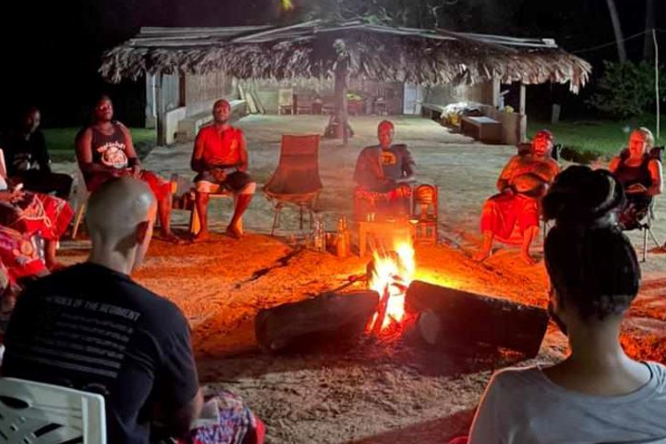 As the night embraces Moughenda Village in Gabon, men and women gather around a ceremonial fire to hear Shaman Moughenda share the wisdom of the Bwiti tradition. As the fire crackles and dances, its warm glow illuminates the faces of those gathered around, creating a space of unity and transformation where spirits are lifted and hearts are kindled.